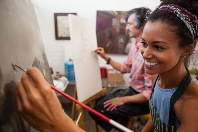 Smiling Woman and Man Painting on Canvas in Art Class - Download Free Stock Photos Pikwizard.com