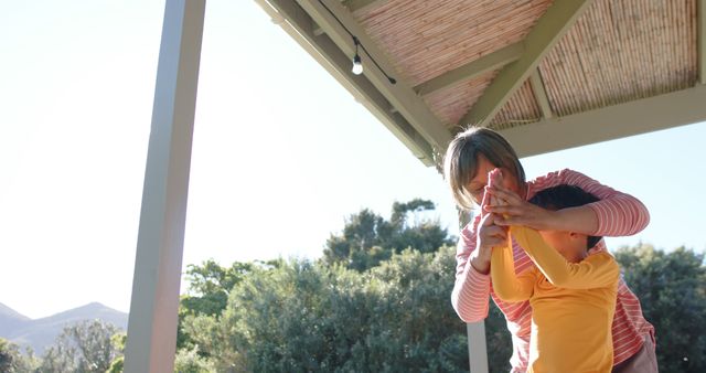 Mother Playing with Child on Porch Under Sunny Sky - Download Free Stock Images Pikwizard.com