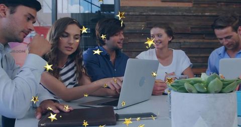 Business Team Collaborating in Stylish Office with Laptops and Decor