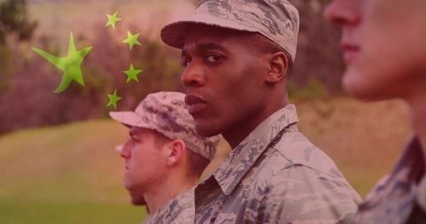 Focused soldier in formation wearing camouflage uniform and patrol cap with star overlay
