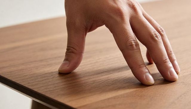 Pressing hand tracing wood grain on veneer panel for furniture detail and surface quality