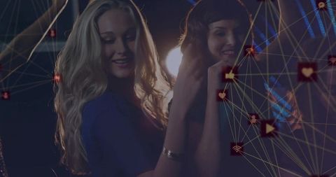 Friends dancing amidst glowing digital connectivity at nightclub party