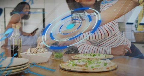 Friends preparing pizzas at kitchen island with mushrooms and futuristic hud overlay, social gatheri