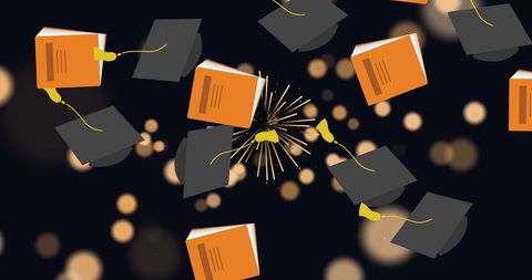 Celebratory graduation caps and books with fireworks