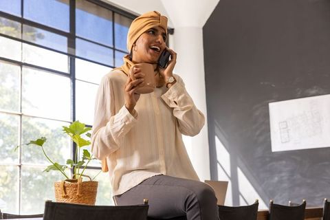 Asian Indian Woman Talking on Smartphone at Modern Office