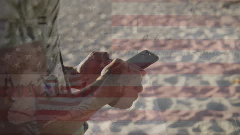 American Patriotism Overlay with Person Using Smartphone on Beach