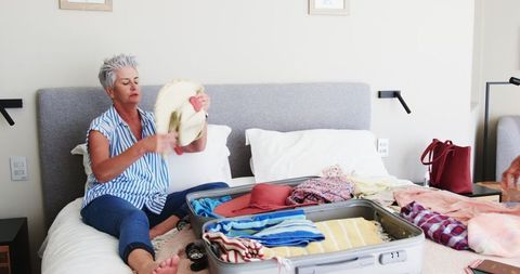 Senior Couple Preparing for Vacation with Passion and Excitement