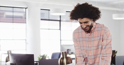 Smiling male professional begins new job in modern office
