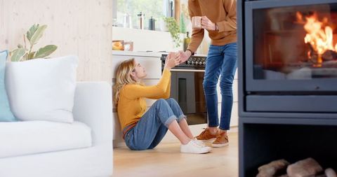 Couple enjoys relaxing moment in modern kitchen by cozy fireplace