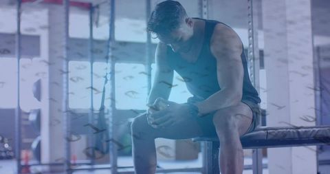 Man Resting in Gym for Strength and Motivation