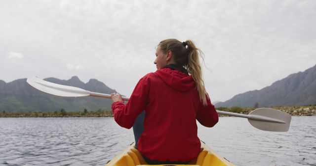 Young Woman Kayaking on Serene Lake, Mountain Background - Download Free Stock Images Pikwizard.com