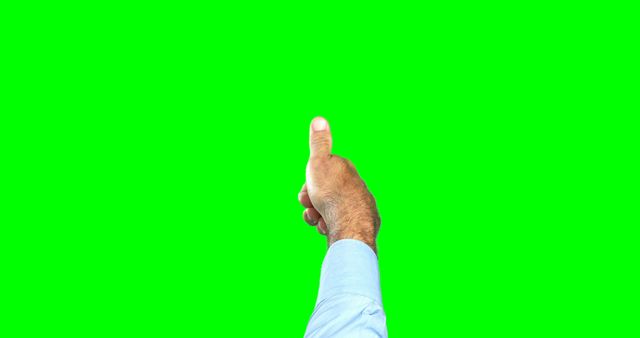 A middle-aged man's hand is giving a thumbs up against a green background, with copy space. The gesture typically signifies approval or agreement in many cultures.