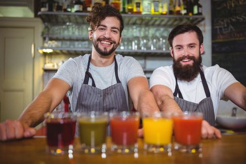 Smiling Baristas Serving Colorful Fresh Juices