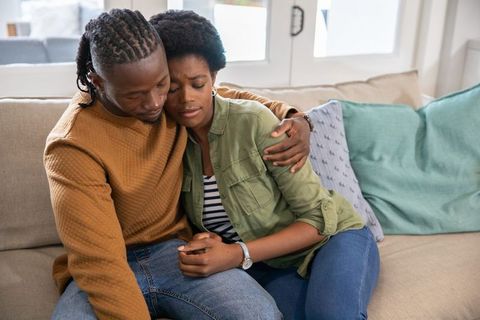 Intimate african american couple relaxing together at home