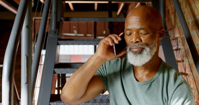 Mature Man with Beard Talking on Phone Sitting on Stairs - Download Free Stock Images Pikwizard.com