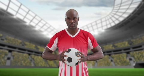 Soccer Player Holding Ball in Stadium