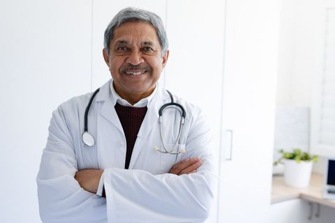 Confident Senior Doctor Smiling in Medical Office - Download Free Stock Images Pikwizard.com