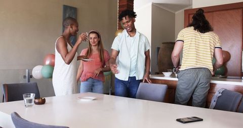 Friends Gathering at Home Preparing for Celebration