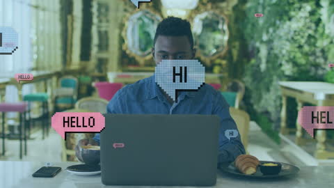 Man Working in Café Surrounded by Digital Speech Bubbles