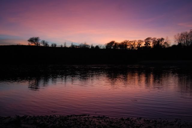 Vibrant Sunset Silhouette Over Tranquil Lake - Download Free Stock Photos Pikwizard.com