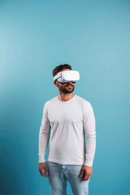 Caucasian man wearing vr and ar headset on blue background, created using generative ai technology. Augmented and virtual reality and technology concept digitally generated image.