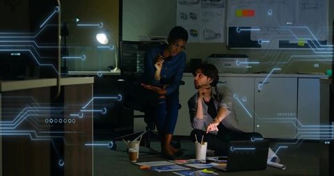 Evening tech design meeting in dimly lit office