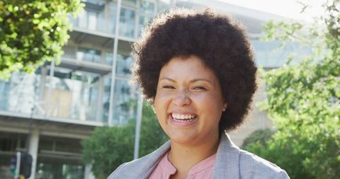 Joyful Biracial Woman Smiling in Urban Setting Embracing Inclusivity