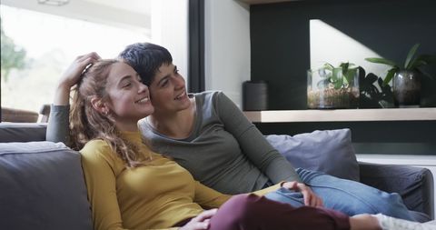 Happy Lesbian Couple Relaxing on Sofa in Cozy Living Room - Download Free Stock Images Pikwizard.com