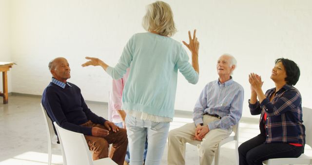 Senior group participating in chair exercises in bright room - Download Free Stock Images Pikwizard.com