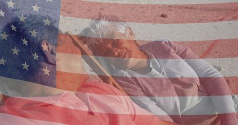 Senior Couple Relaxing on Beach with USA Flag Overlay