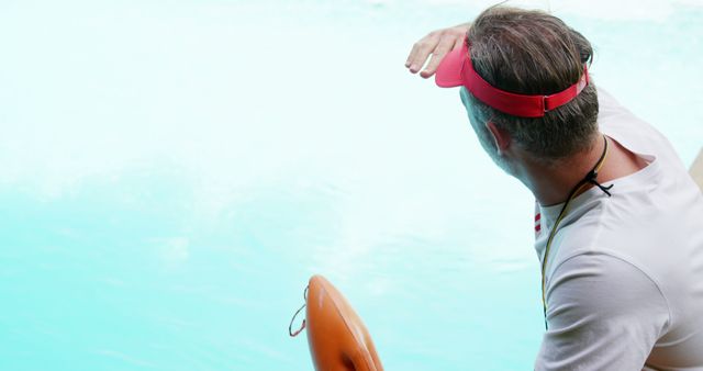 Lifeguard Overlooking Pool with Whistle and Buoy - Download Free Stock Images Pikwizard.com