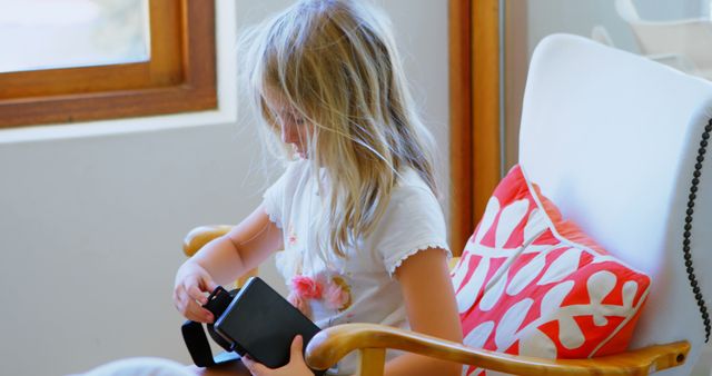 Young Girl Exploring Vintage Camera in Cozy Living Room - Download Free Stock Images Pikwizard.com