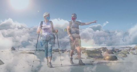 Mature Couple Hiking Coastal Shore with Trekking Poles and Masks