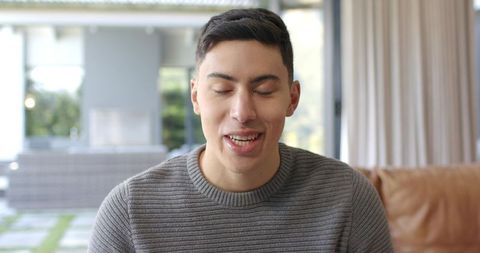 Young Man Relaxing and Speaking in Modern Living Room Setting