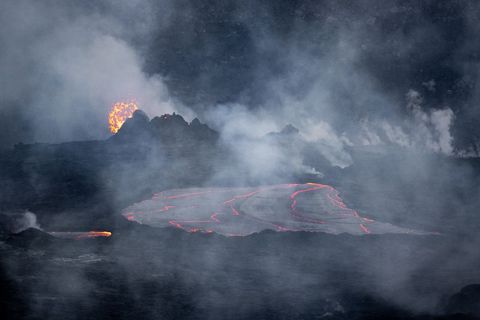 Erupting Volcanic Landscape with Flowing Lava and Smoke