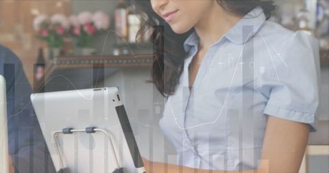 Businesswoman Using Tablet with Data Overlay in Modern Office