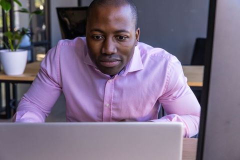 Professional working on laptop in modern office environment