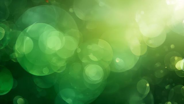 Emerald and lime bokeh glow abstract background with soft circular light orbs