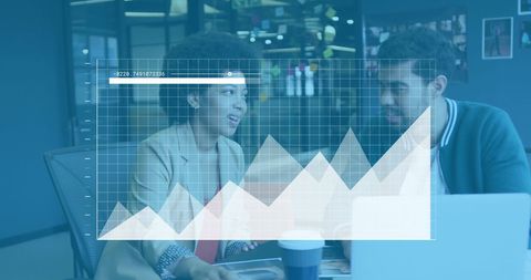 Overlay of financial data over diverse employees analyzing in office