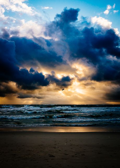 Dramatic Sunset Over Stormy Ocean and Sandy Beach - Download Free Stock Photos Pikwizard.com