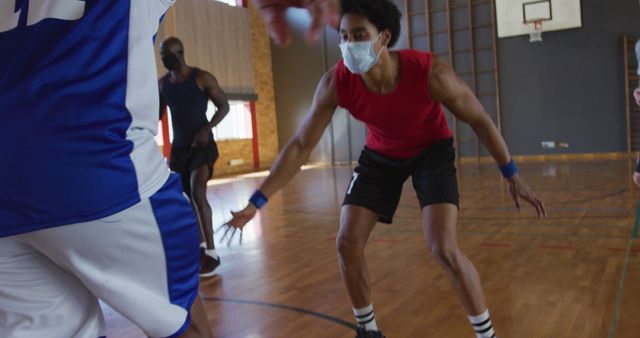 Diverse male basketball team and coach playing match, wearing face masks - Download Free Stock Photos Pikwizard.com