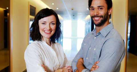 Confident executives in modern office corridor