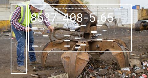 Supervisor Inspecting Hydraulic Machine in Recycling Facility
