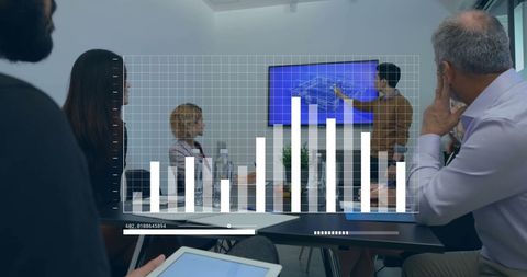 Diverse business team analyzing financial data on screen