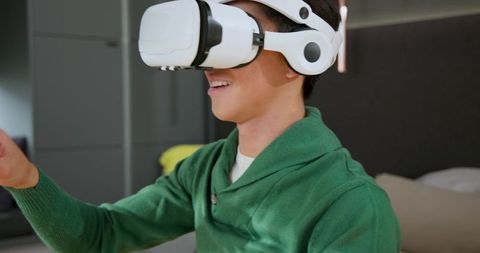 Adult male engaging with virtual world using vr headset at home