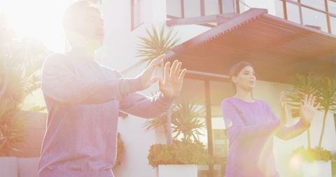 Couple Practicing Tai Chi in Sunny Garden Setting