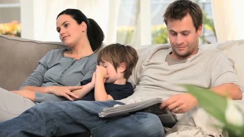Happy Family Relaxing on Couch Spending Quality Time Together