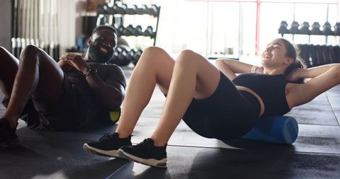 Fitness enthusiasts using foam rollers diverse workout dynamics