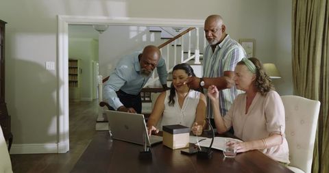 Diverse Elderly Friends Engaging with Technology at Home