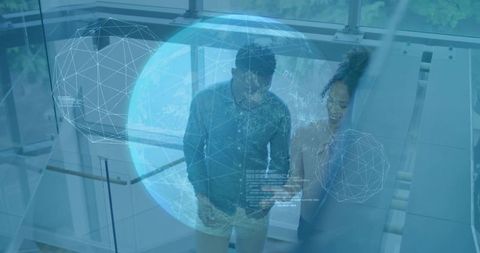 Professionals Discussing Technology in Modern Atrium with Holographic Globe